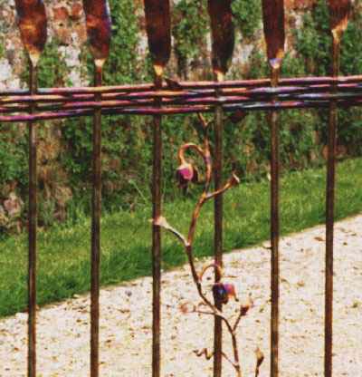 A detail of woven bars and a metal flower.